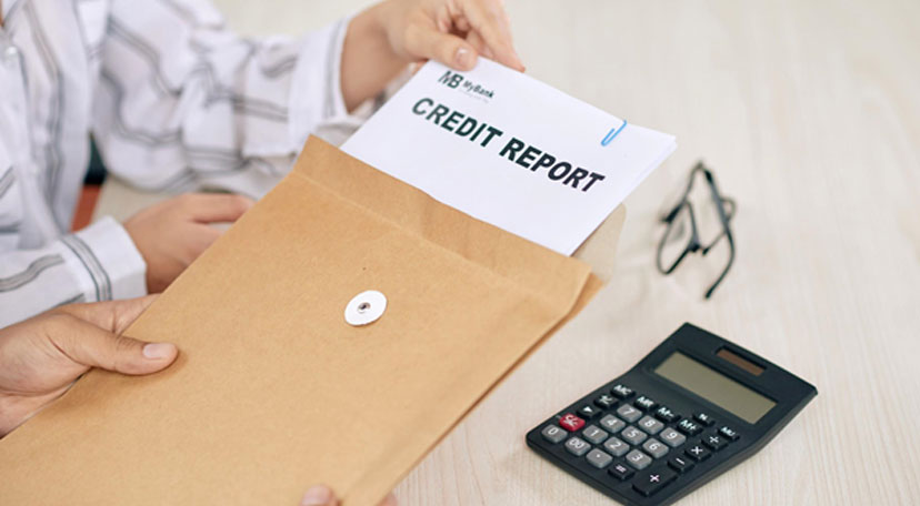 woman showing credit report papers to client