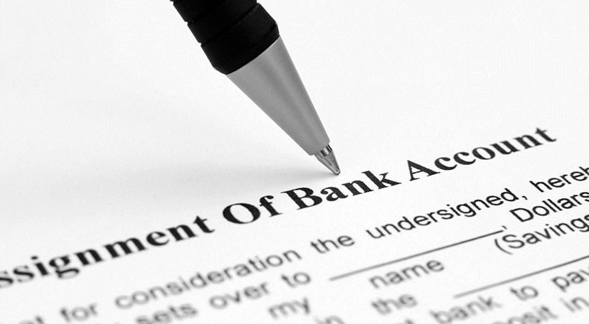A pen signing a document to open a corporate bank account